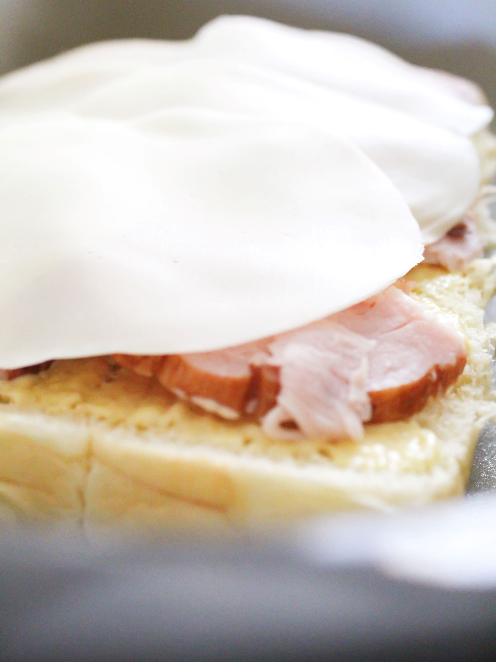 Close up view of provolone cheese layered on top of turkey sliders