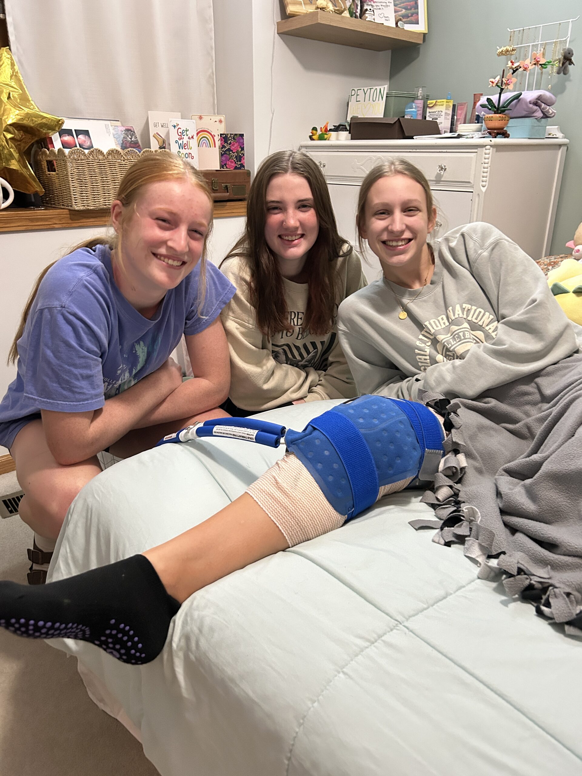 girl smiling post surgery with friends