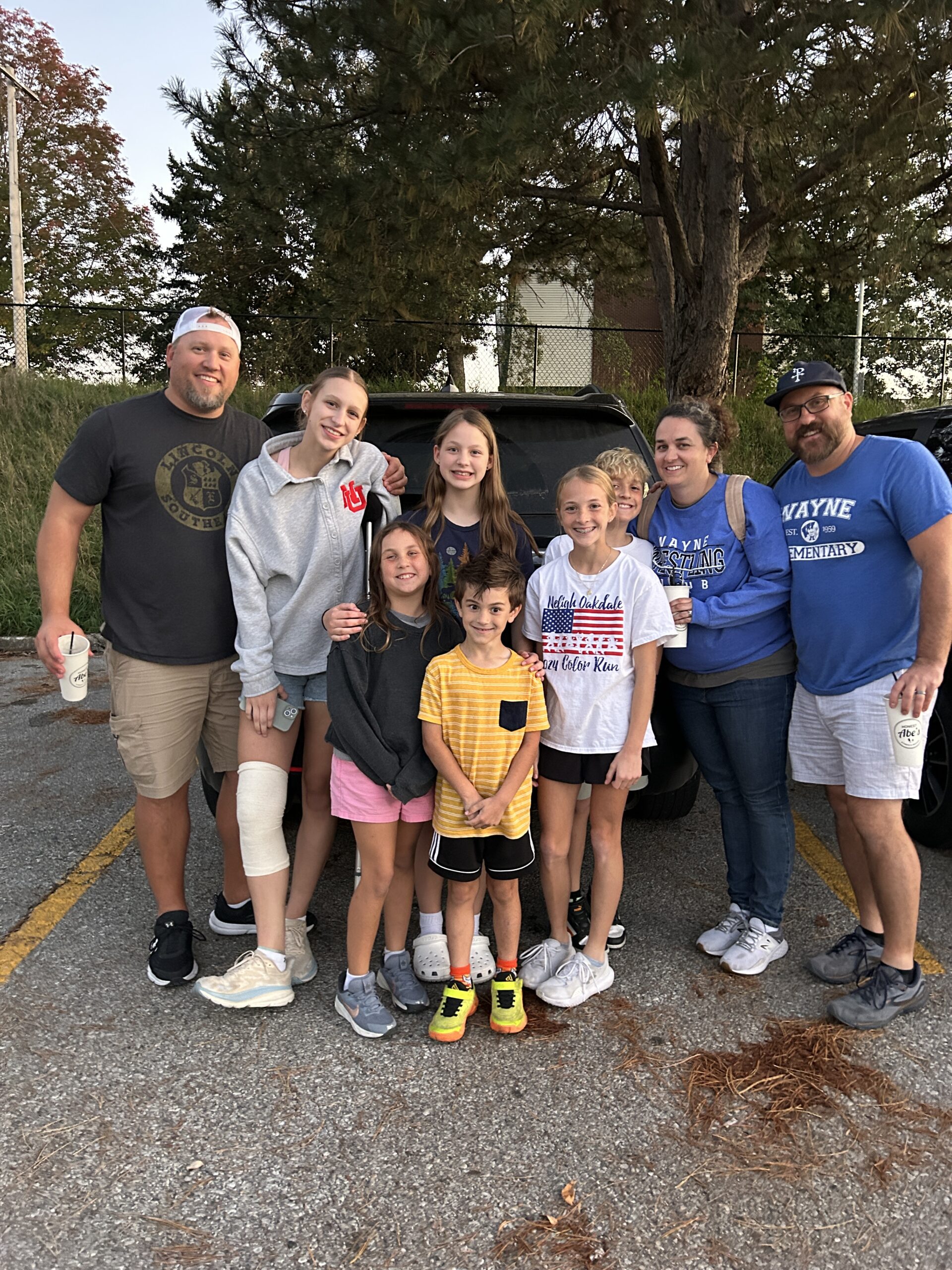 Extended family standing and smiling after a dinner together