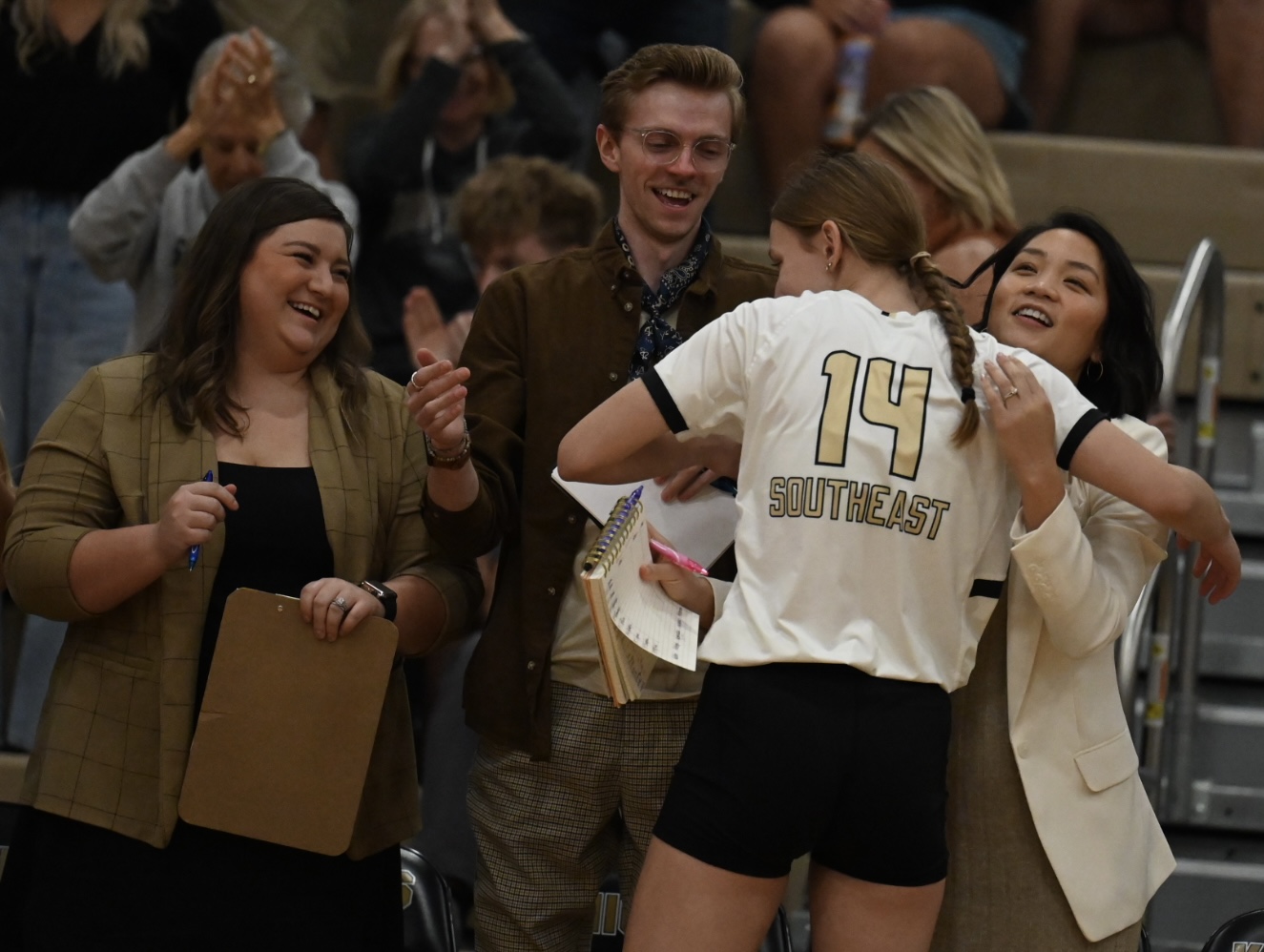 volleyball player hugging coaches after coming off of the court
