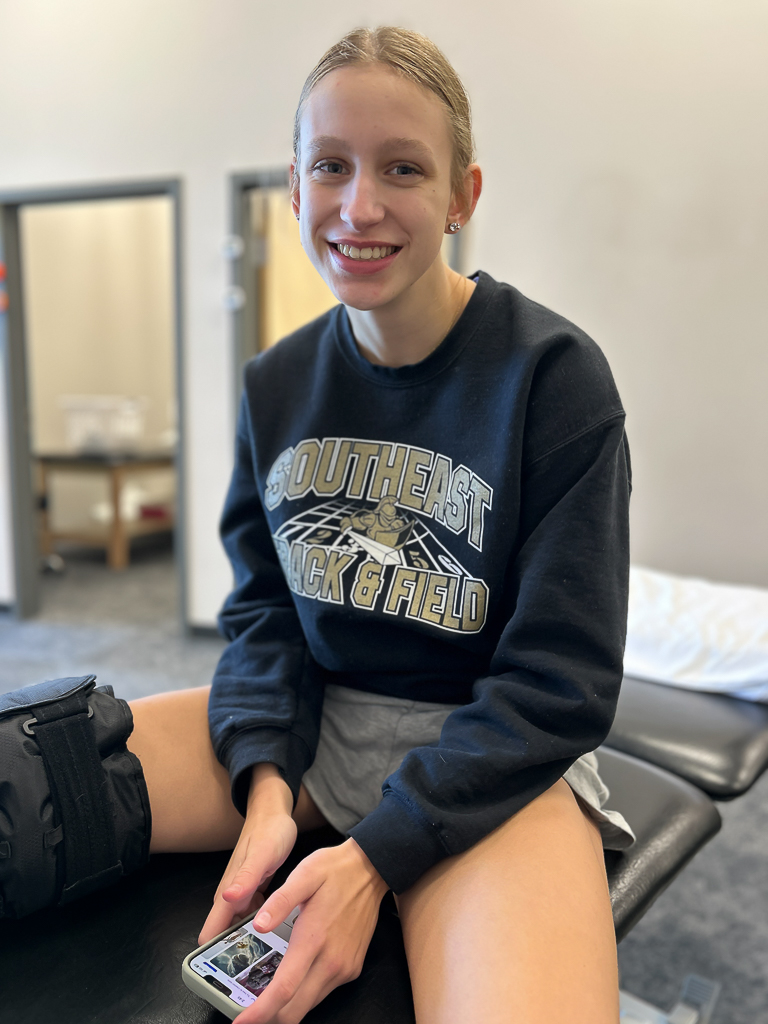Girl smiling during physical therapy for ACL rehab