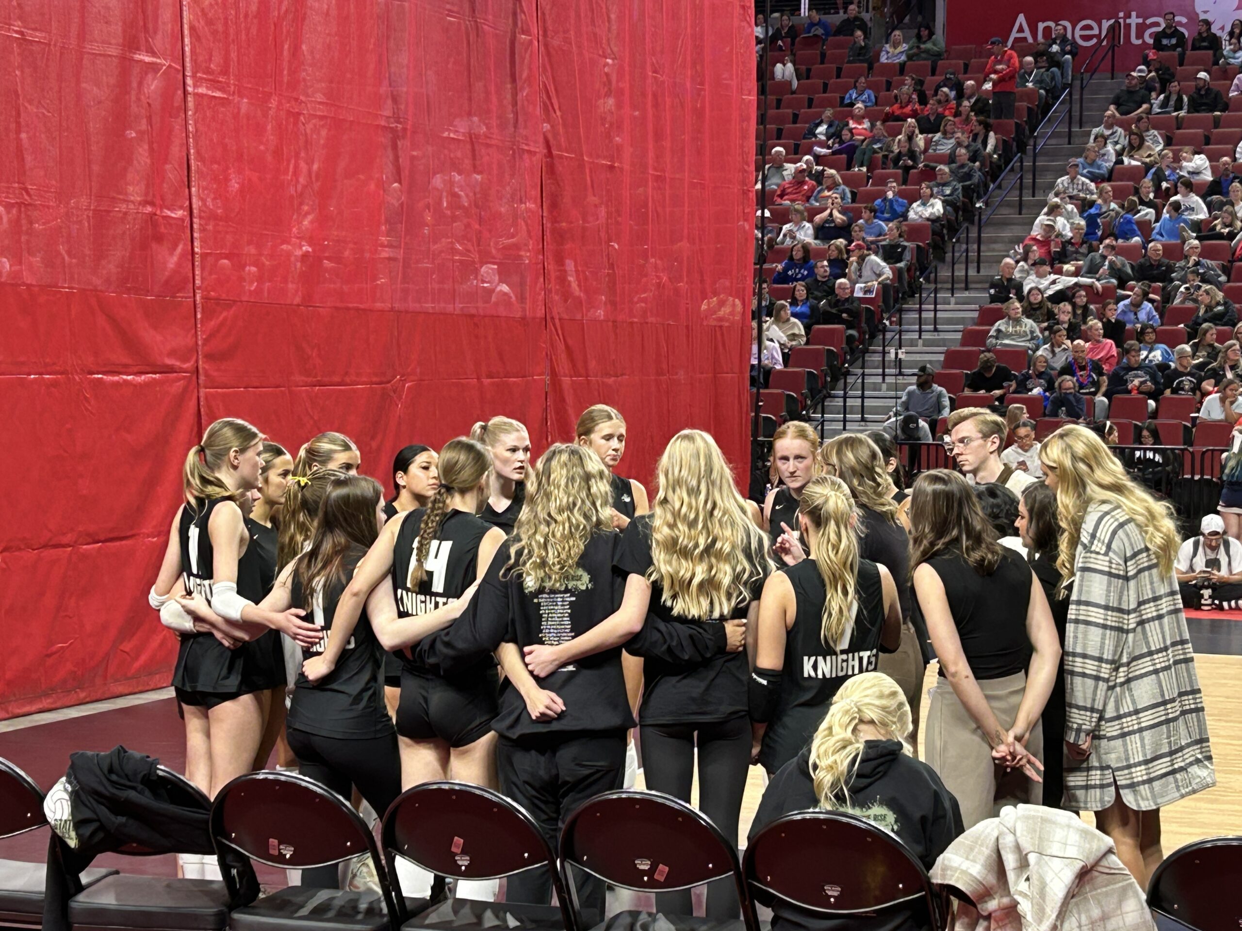 a volleyball team huddling before the match