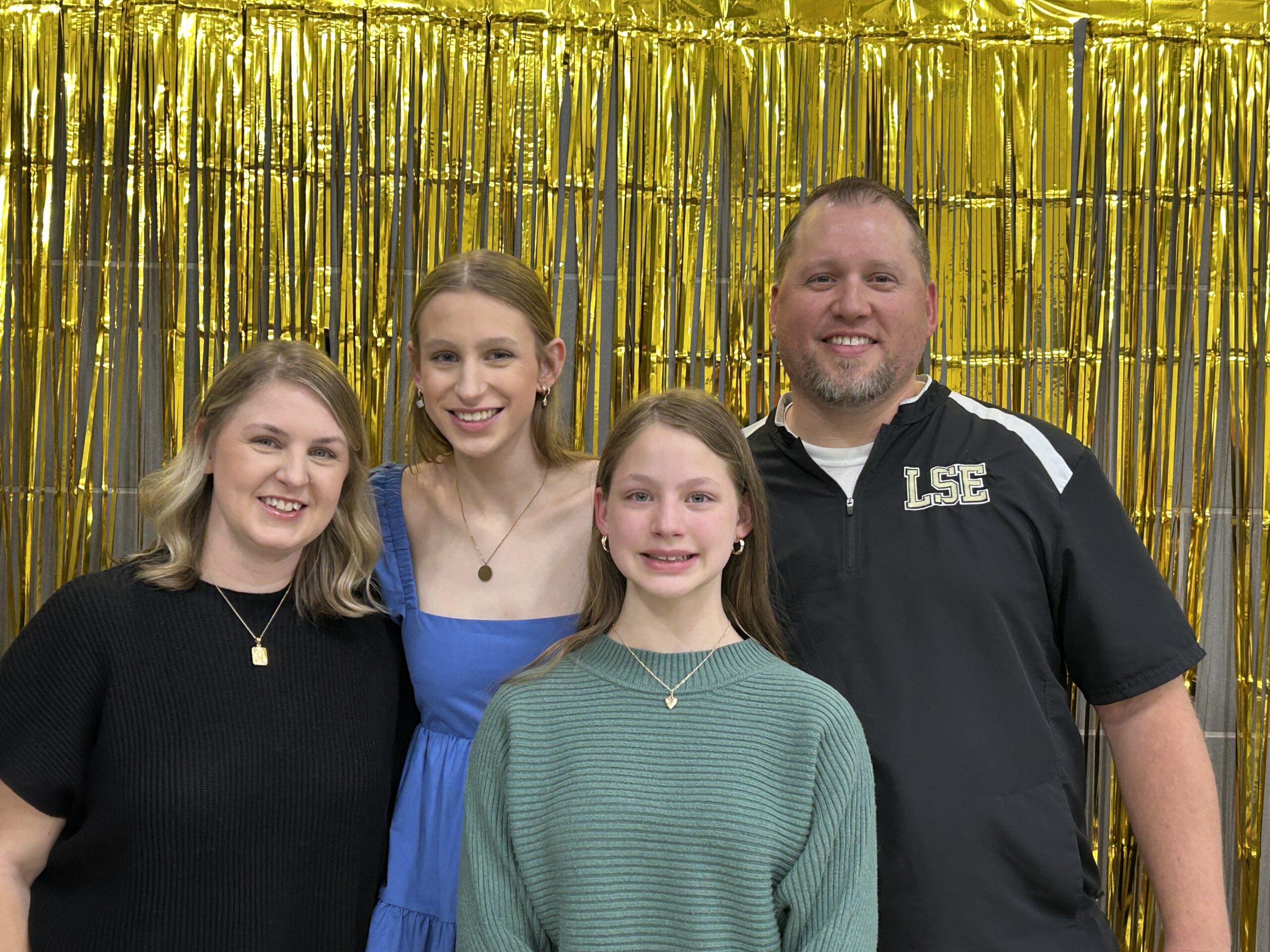 smiling family at the end of the year volleyball banquet
