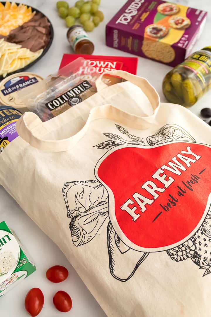Fareway grocery bag with pre-made meat and cheese tray, crackers, and produce to make a Christmas charcuterie board