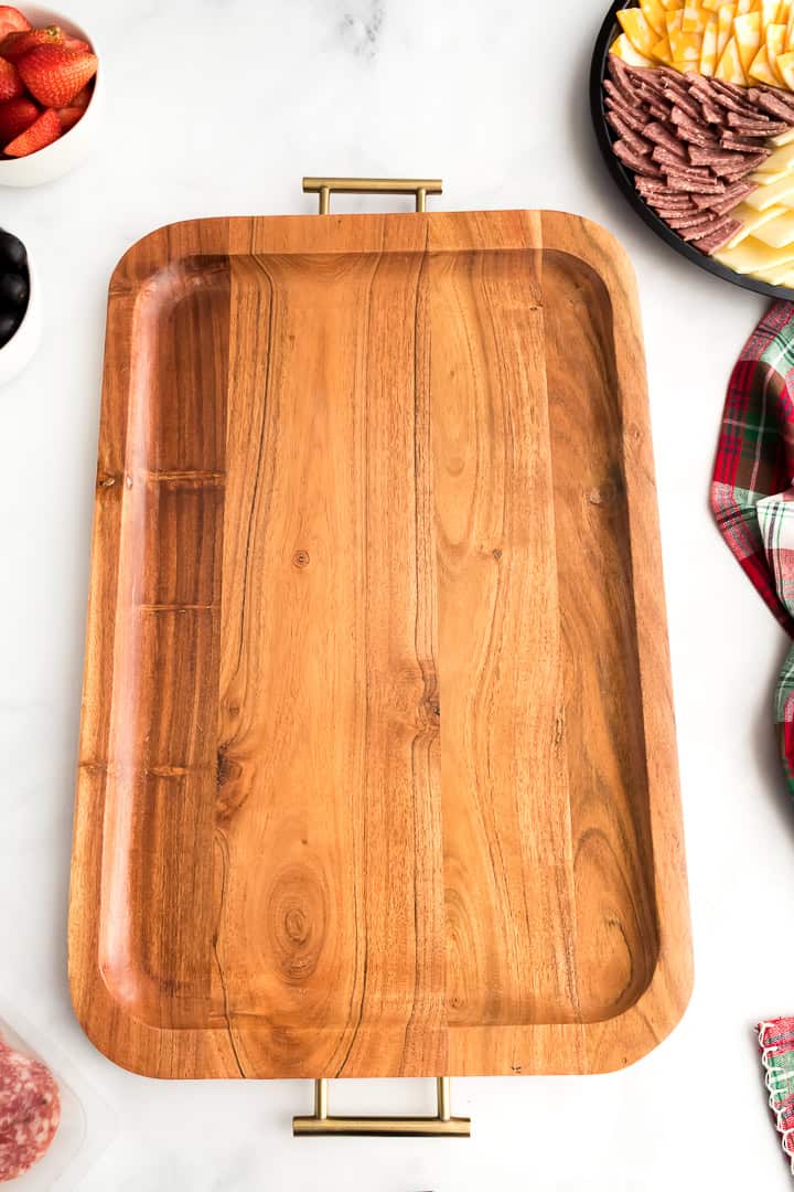 Laying out cheese slices to make a Christmas charcuterie board