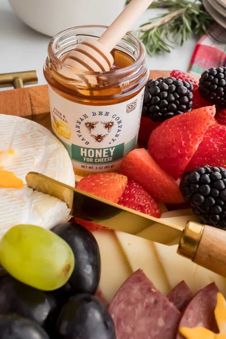 Close-up of small honey jar on a Christmas charcuterie board