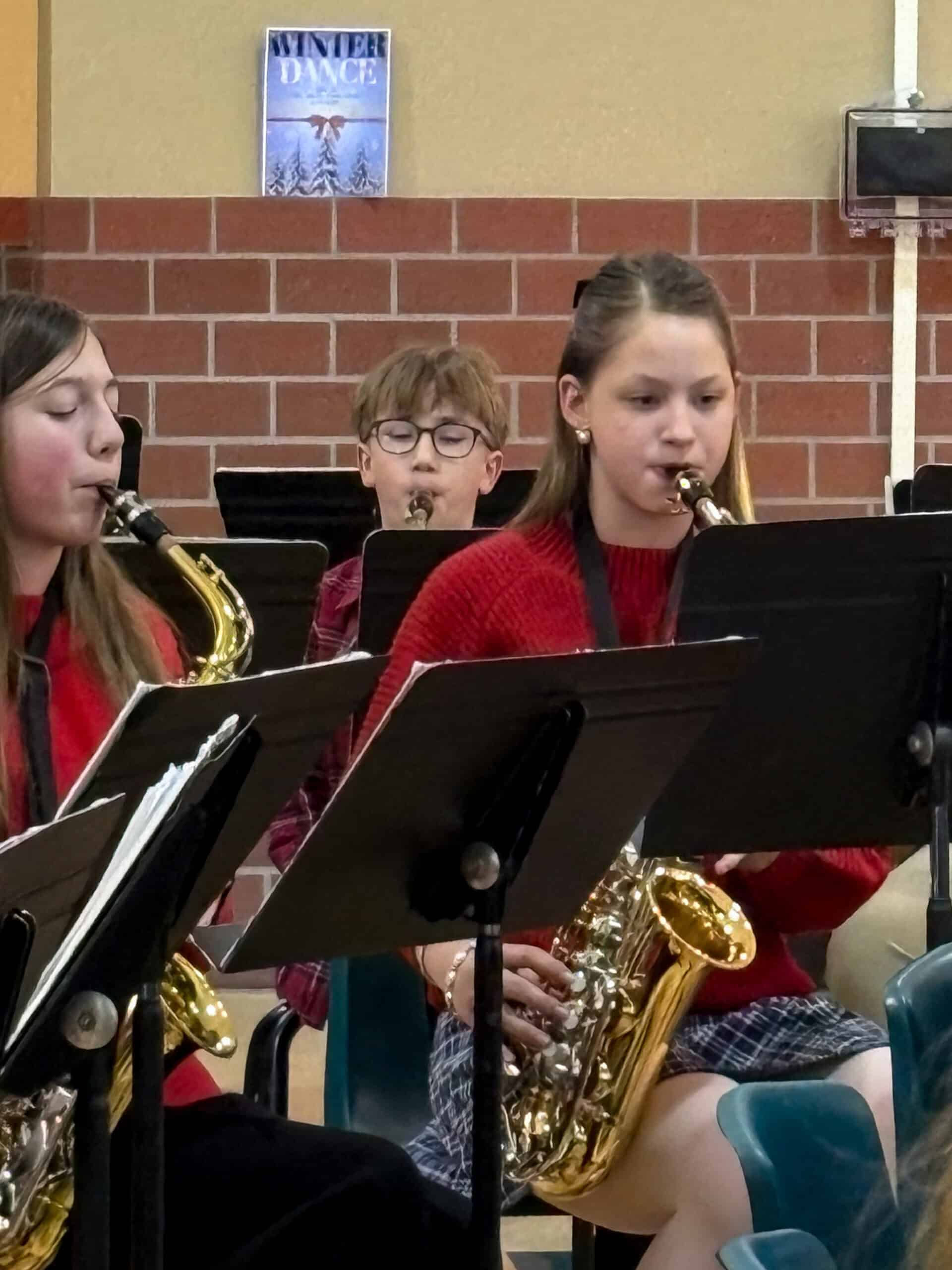 Girl playing saxaphone in school winter concernt