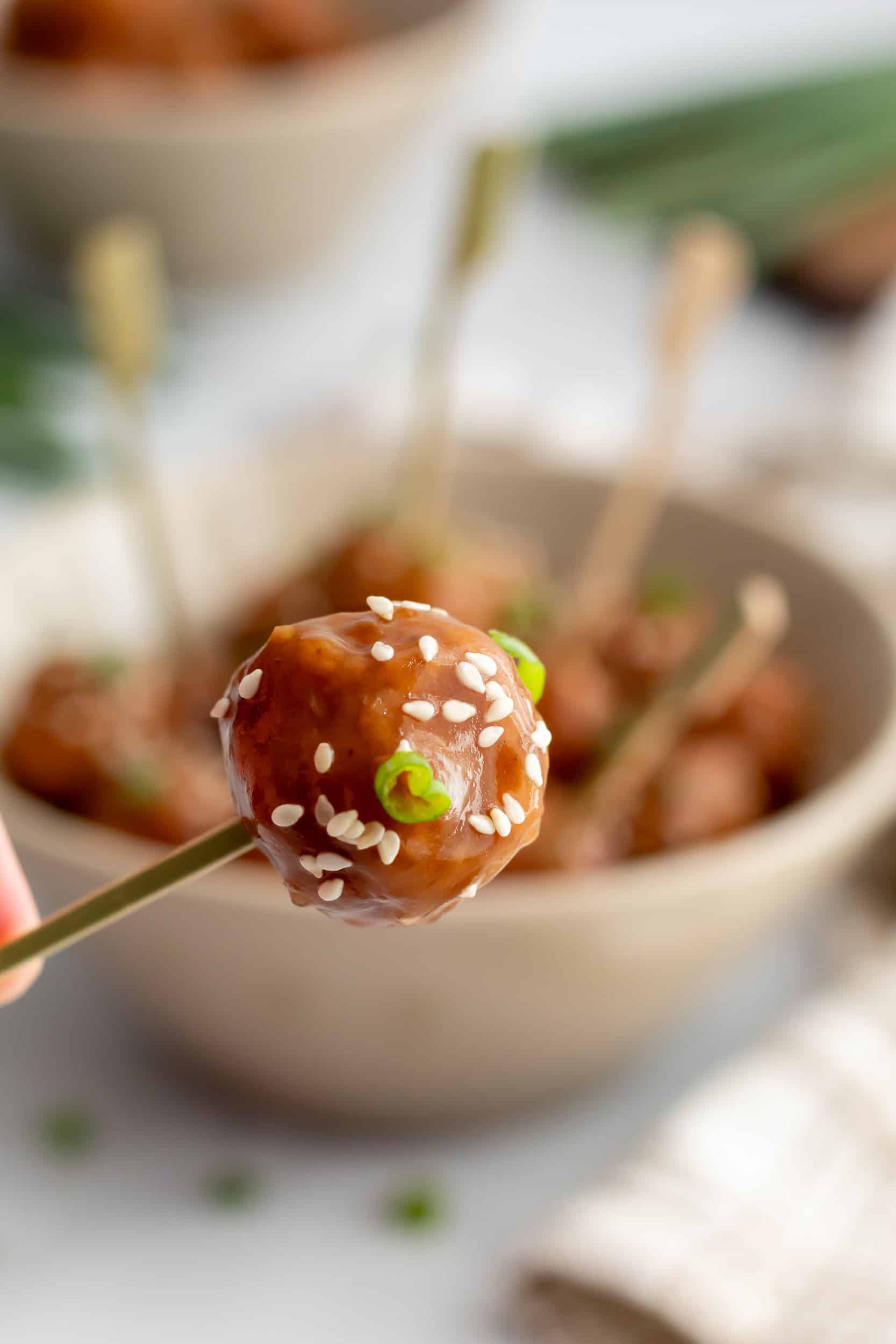 Crockpot teriyaki meatballs served with toothpicks in a bowl, ready for an easy appetizer or party snack.