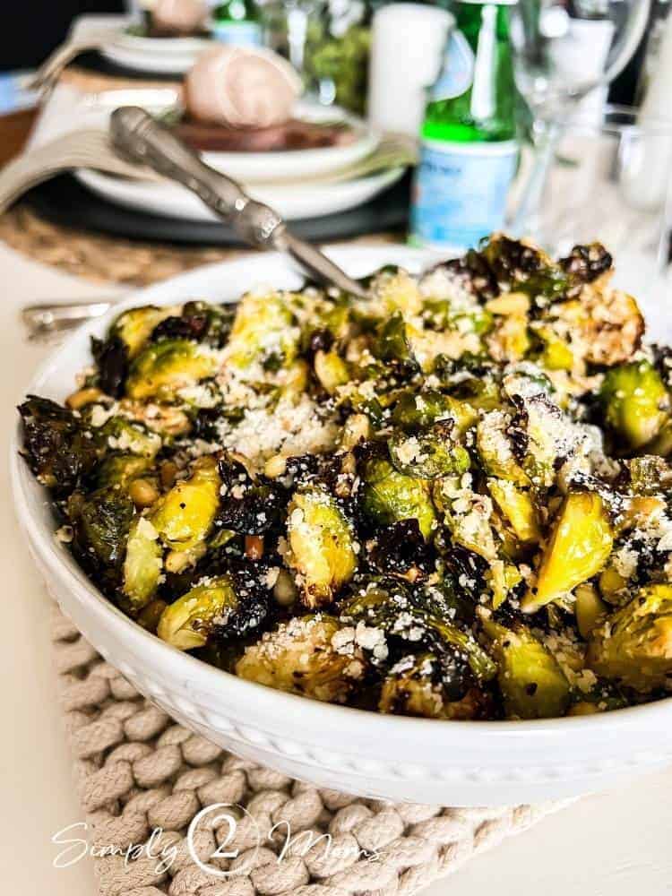 Bowl of crispy air fryer roasted garlic brussles sprouts side dish for an Italian dinner party menu