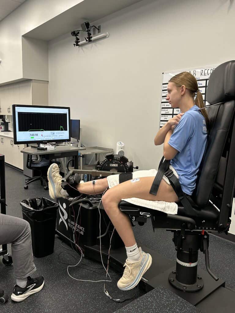 Girl strapped up to testing equipment during ACL rehab testing