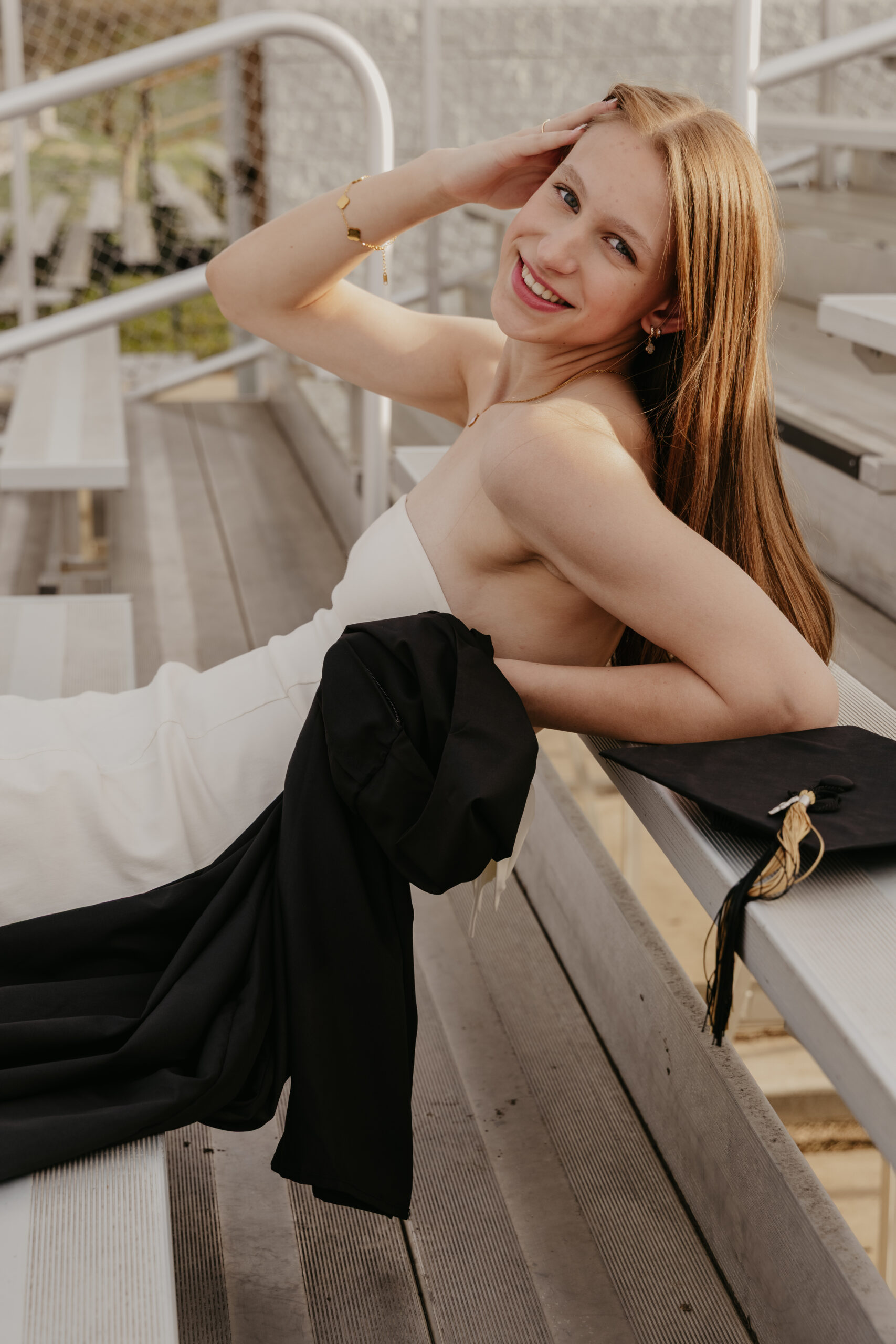 Girl smiling for high school graduation cap and gown photos
