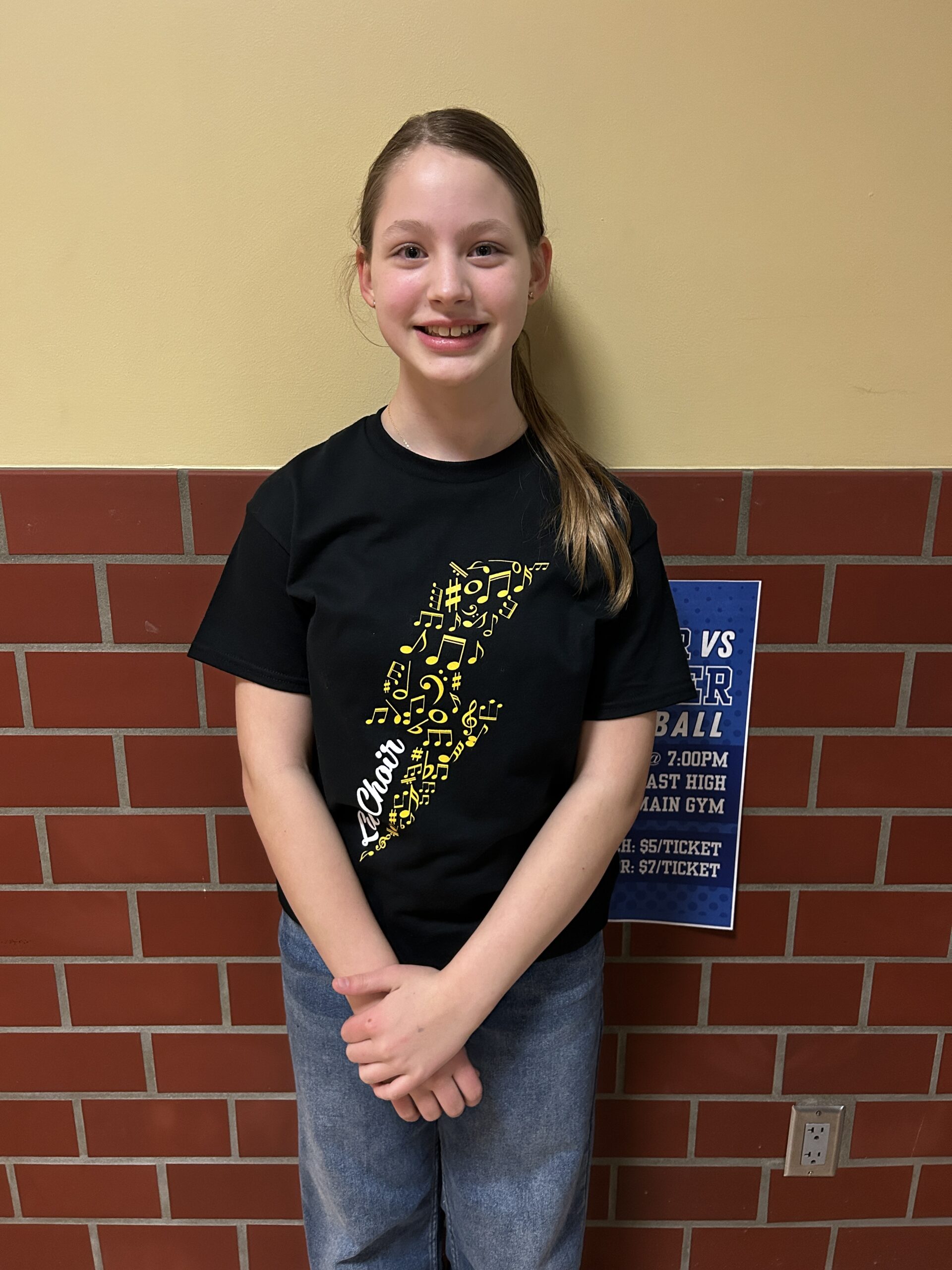 Show choir member standing and smiling after a concert