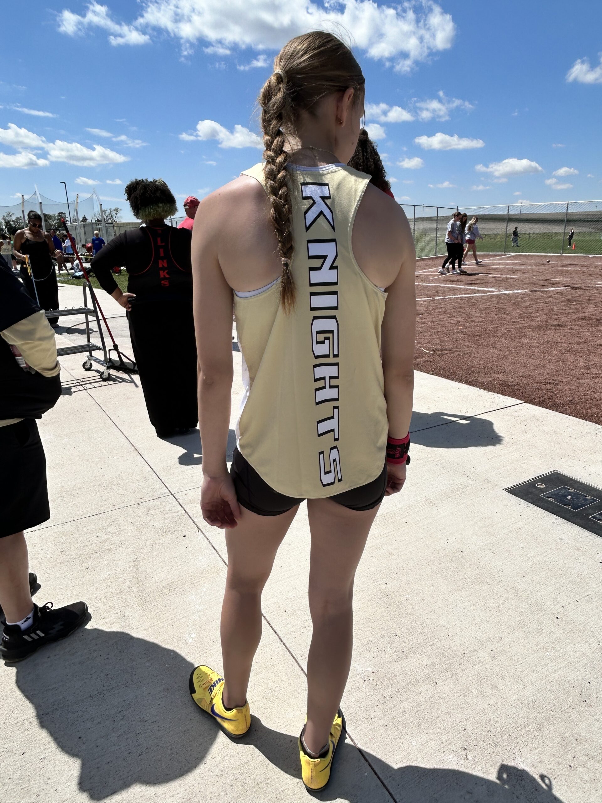 Athlete standing in a track uniform before throwing the shot put