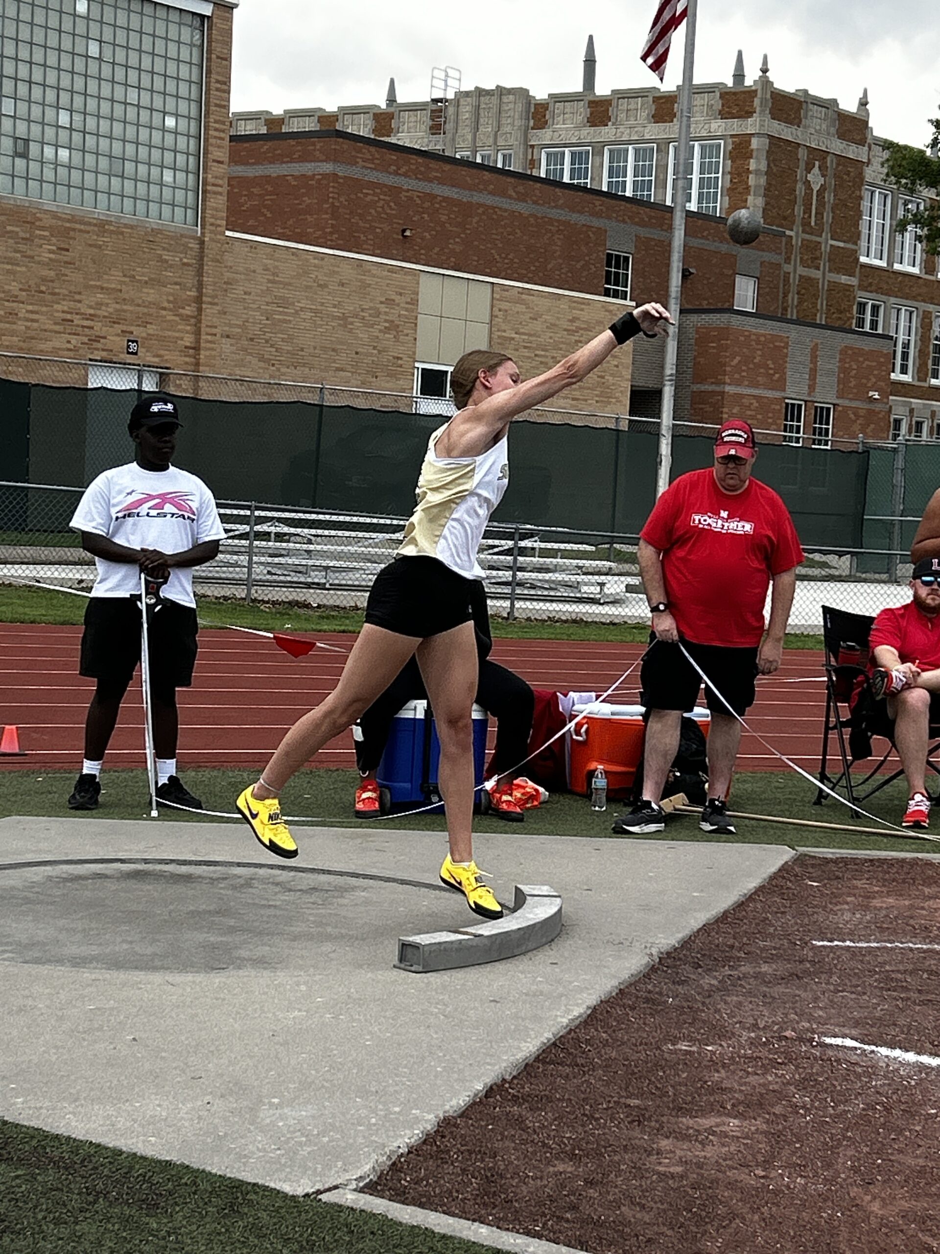 Girl throwing the shot put at the distict track meet at Lincoln High's track and field complex