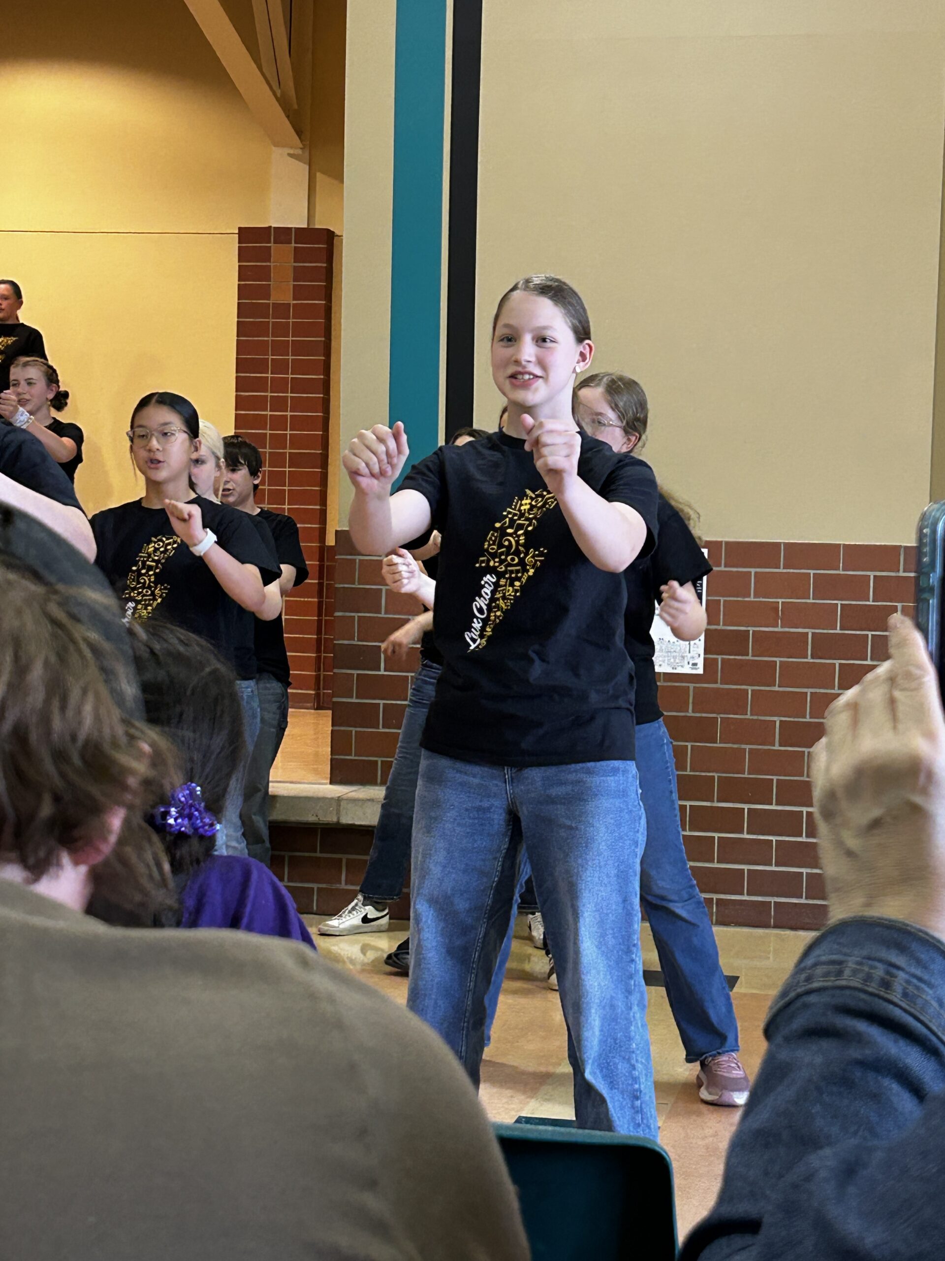 Girl performing in end of the year middle shool show choir concert