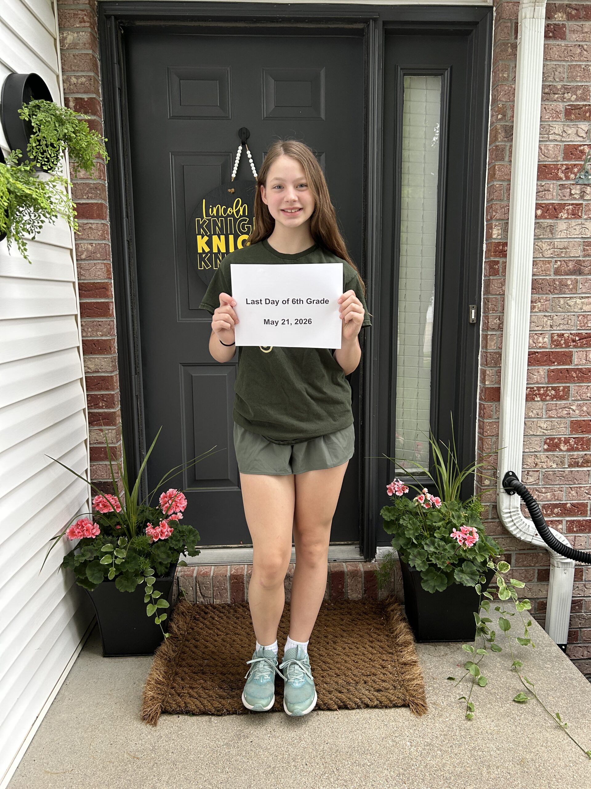 Last day of school photos on the porch with 6th grade girl