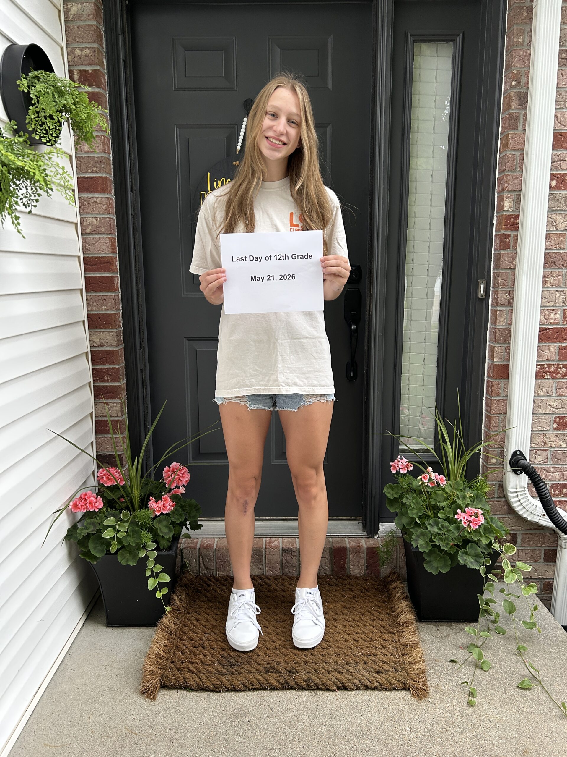 Last day of school photos on the porch with senior girl