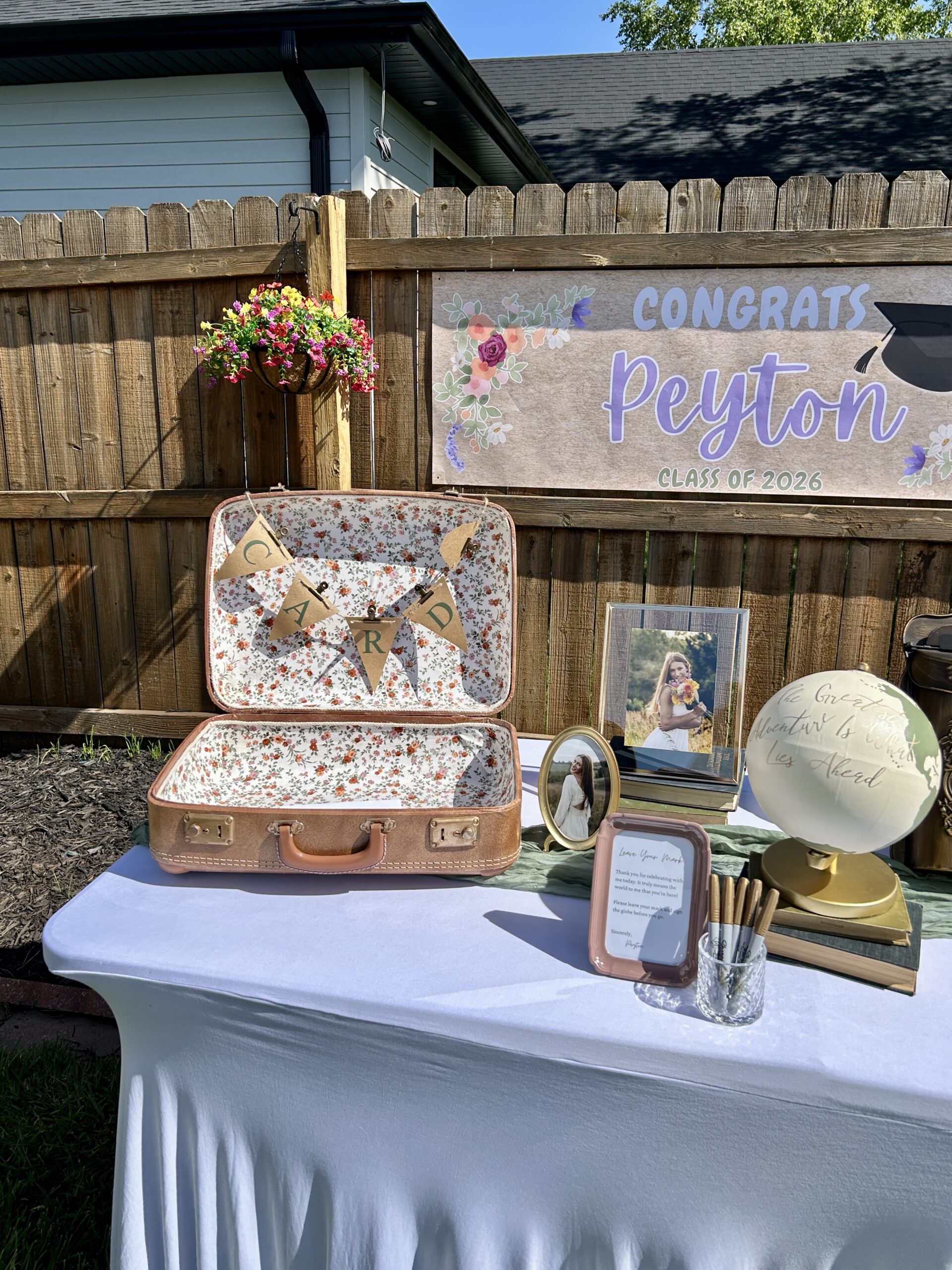 Closer view of the graduatio guest book table at the vintage and floral themed graduation party