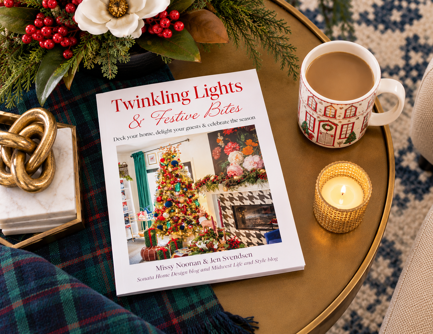 Twinkling Lights & Festive Bites holiday entertaining guide styled on a brass table with a Christmas mug, candle, greenery, and plaid blanket.