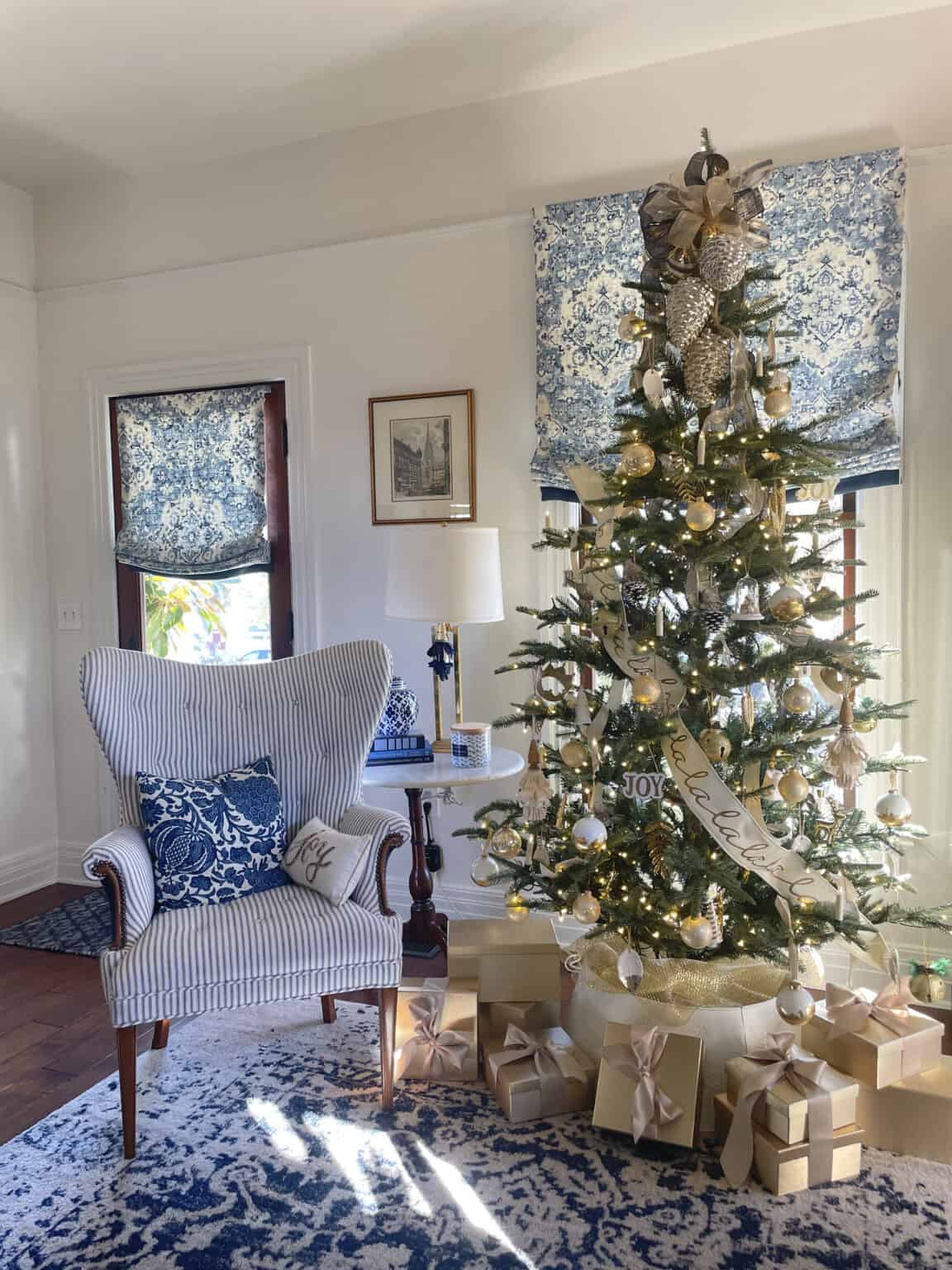 Gold and white holiday color palette on a Christmas tree decorated with gold and white ornaments, ribbon, and coordinating wrapped gifts.